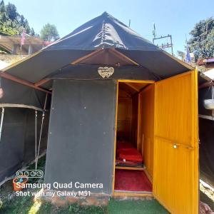 a large tent with a door open and a room at Himalayan Wooden Cottage camping & Cafe Dalhousie in Dalhousie +21 photos