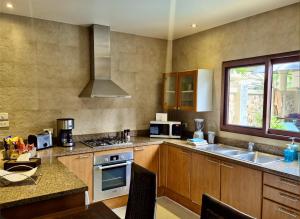 a kitchen with a sink and a stove top oven at Sibaja Palms Sunset Beach Luxury Villa in Taling Ngam Beach