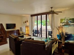 a living room with two couches and a table at Sibaja Palms Sunset Beach Luxury Villa in Taling Ngam Beach +38 photos