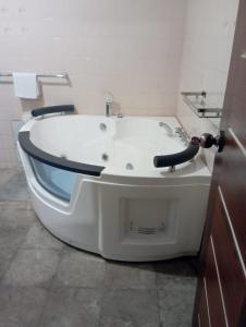 a white bath tub in a bathroom with a sink at Country Homes Srilanka in Mount Lavinia