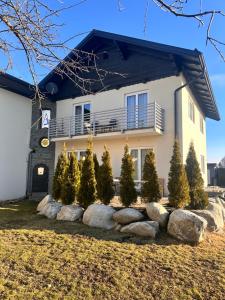 a house with a bunch of trees and rocks at RingRooms - Self Check-In in Knittelfeld