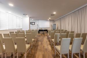 an empty room with chairs and a podium in it at Hotel Cristallo in Riccione