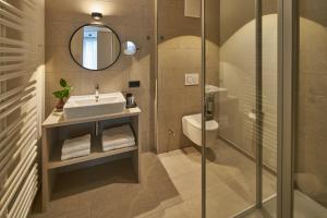 a bathroom with a sink and a shower at Michels Dependance des Hotel Misan in Norderney +9 photos