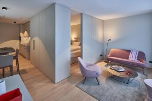 a living room with a couch and a table at Michels Dependance des Hotel Misan in Norderney