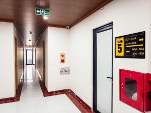 a hallway in a building with a sign on the wall at Tiến Thành Hotel Nghệ An in Vinh +27 photos