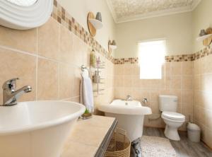 a bathroom with a white sink and a toilet at Wölfe Krantz Accommodation in Nelspruit