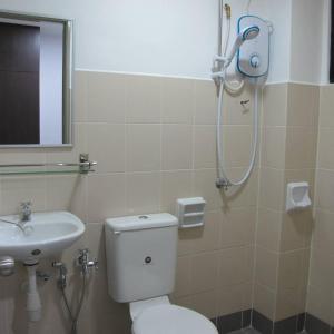 a bathroom with a shower and a toilet and a sink at Pangkor Lot 10 Moonlight in Kampong Sungai Udang