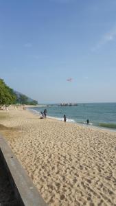 a beach with people on the sand and the ocean at Pangkor Lot 10 Moonlight in Kampong Sungai Udang