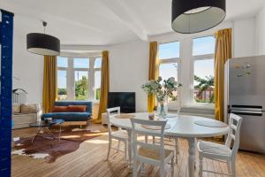 a living room with a white table and chairs at Cozy Antwerp - Sunny Zurenborg in Antwerp