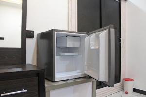 an open refrigerator sitting on a counter in a kitchen at R&B Guest House in Jaffna