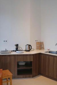 a kitchen counter with two pots and pans on it at 1909 Home Dalat - Open 24h in Ấp Kim Thạch