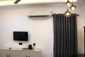 a room with a black curtain and a tv at R&B Guest House in Jaffna +15 photos