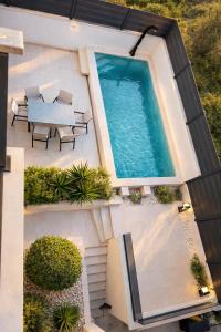 an overhead view of a swimming pool on a house at Wind Rose Maestral-beachfront in Igrane