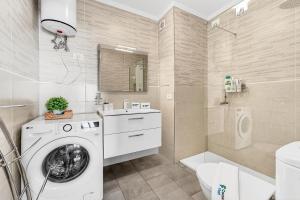 a bathroom with a washing machine and a toilet at Atlantic Penthouse Retreat in Costa Del Silencio