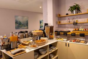 a kitchen with a buffet of food on a counter at Queen Mary Opera in Paris