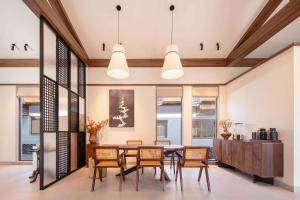 a dining room with a table and chairs at ZSZ Hot Spring Resort in Shajing