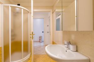 a bathroom with a sink and a shower at Suite Des Etrangers -Parcheggio privato- Private parking in Sanremo +45 photos