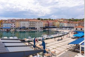 a marina with boats in the water and buildings at Vila Inar Cres in Cres