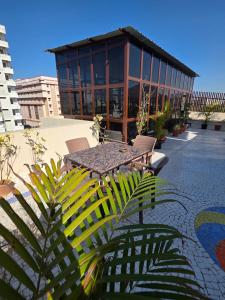 a patio with a table and chairs and a building at Ghare Stays Udaipur in Udaipur