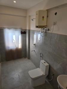 a bathroom with a toilet and a sink at Ghare Stays Udaipur in Udaipur +28 photos
