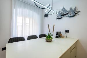 a white table with a potted plant on top of it at Vila Inar Cres in Cres