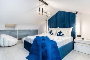 a blue and white bedroom with a bed and a chandelier at Vila Inar Cres in Cres +58 photos