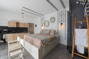 a bedroom with a bed and a kitchen at K Studios in Faliraki