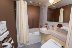 a bathroom with a sink and a toilet and a shower at Toshi Center Hotel in Tokyo +70 photos