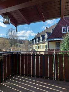 a balcony with a wooden fence and houses at Apartment Erzgebirgsperle in Schwarzenberg +5 photos