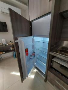 an empty refrigerator with its door open in a kitchen at Casa Vacanze Piccolpasso 20 in Urbania