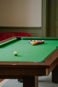 a green felt pool table with a ball and a cue at ARCHE Dwór Uphagena Gdańsk in Gdańsk +83 photos