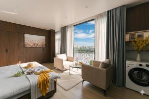a hotel room with a bed and a balcony at Chic & Stylist Studio Lakeview in Hanoi