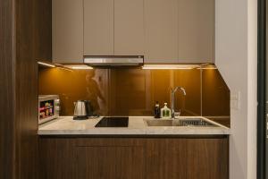 a kitchen with a sink and a microwave at Chic & Stylist Studio Lakeview in Hanoi