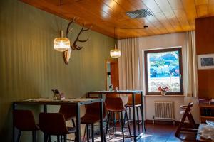 a restaurant with two tables and chairs in a room at Braugast Kreuz in Frastanz