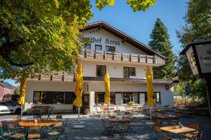 a building with tables and chairs in front of it at Braugast Kreuz in Frastanz