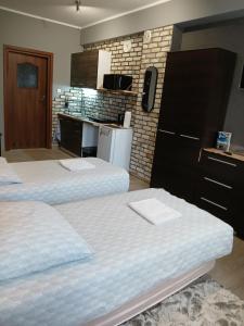 a room with two beds and a kitchen with a counter at Noclegi nad Morzem u Kasi in Gdańsk