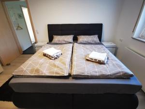 a bed with two pillows on it in a bedroom at Ferienwohnung Im Auricher Tal in Vaihingen an der Enz