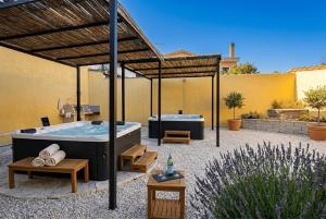 a hot tub sitting in a patio with at Costa Ovest Apartment Waves in Nurachi