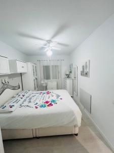 a bedroom with a bed and a ceiling fan at Laguna 88 in La Mata +22 photos
