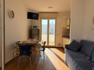 a living room with a table and a couch at Residence il Girasole 1 in Alba Adriatica