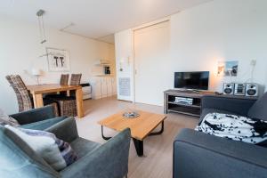a living room with two couches and a table at Vleijenhof Type B in Buren