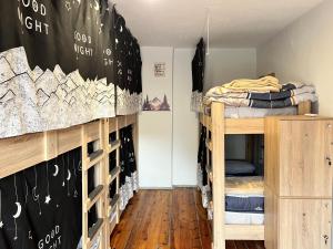 a room with bunk beds and a wall with a chalkboard at Green Door Hostel in Tirana