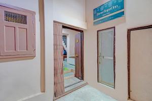 a room with a door and a sign on the wall at Via Shree Gopal Inn in Varanasi