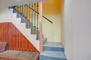 a staircase in a house with a wooden stair case at Via Shree Gopal Inn in Varanasi +22 photos