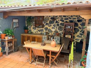 a wooden table and chairs on a patio at Casa Lucía in Breña Baja