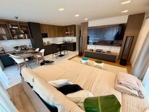 a large bedroom with a large bed and a kitchen at Rupphill Apartment in Budapest