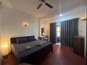 a bedroom with a bed with two towels on it at Bella Sunset Point in Embilipitiya