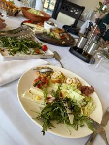a white table with plates of food on it at Hotel Bregu I Detit Erm Spille in Spille