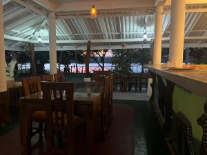 a dining room with a glass table and chairs at Bella Sunset Point in Embilipitiya