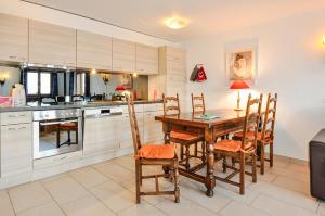 a kitchen with a wooden table and chairs at FeWo im Chalet Schneeflöckli in La Tzoumaz +30 photos